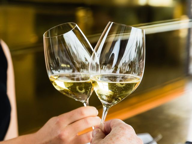 Two hands cheersing RIEDEL Veritas Champagne Glasses filled with Champagne.