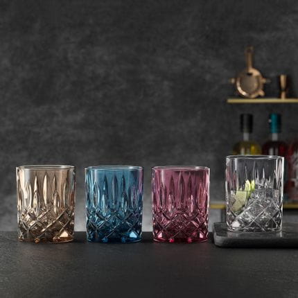 The NACHTMANN Noblesse whiskey tumblers in the vintage colors tobacco, vintage blue, berry and smoke in a row.<br/>