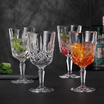 Four NACHTMANN Noblesse cocktail glasses, three of them filled with different Spritz cocktails, one is empty.<br/>